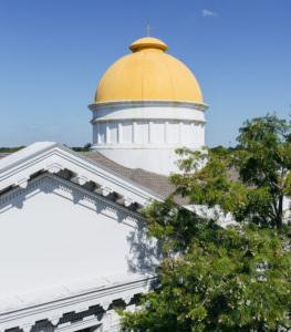 The golden Criswell dome against a backdrop of bright blue sky
